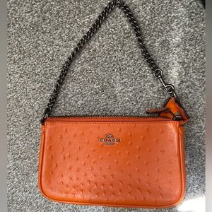 Orange Coach wristlet Purse.